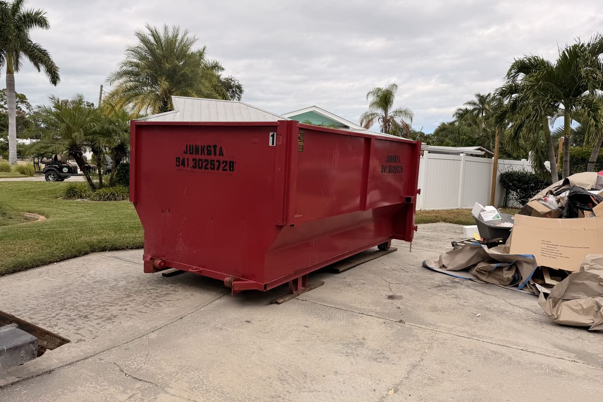 Red Junksta roll-off dumpster delivered in Bradenton, FL