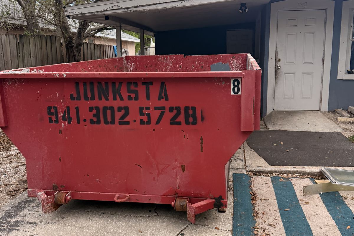 Red Junksta roll-off dumpster delivered in Ellenton, FL