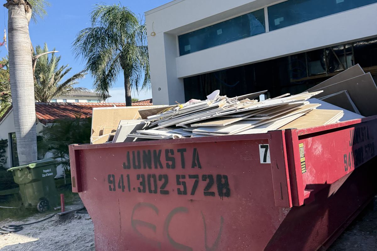 Red Junksta roll-off dumpster delivered in Longboat Key, FL