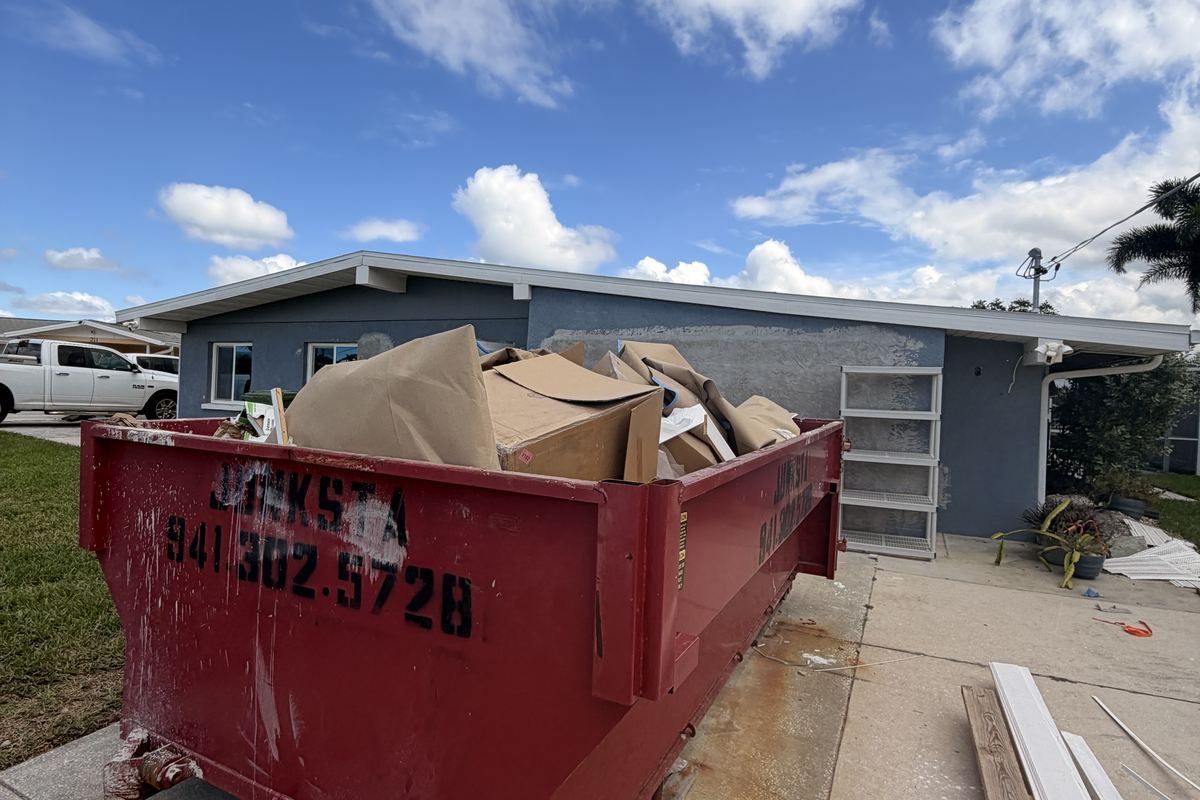 Red Junksta roll-off dumpster delivered in Palmetto, FL