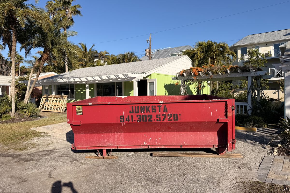 Red Junksta roll-off dumpster delivered in Parrish, FL