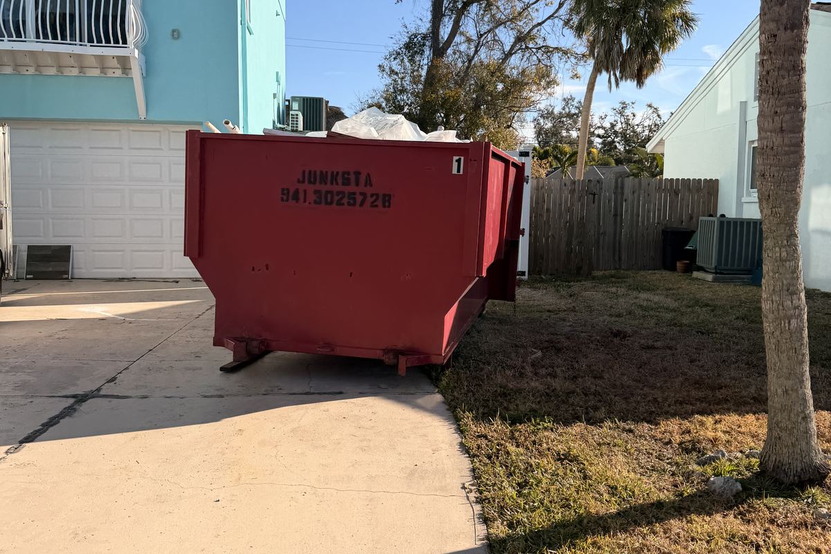 Red Junksta roll-off dumpster delivered in Sarasota, FL