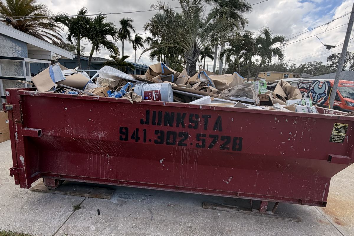 Red Junksta roll-off dumpster delivered in Siesta Key, FL